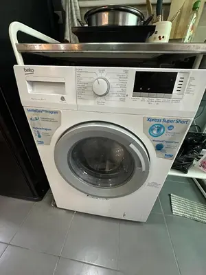 a washing machine is sitting in a kitchen at Cozy Room - On Nut - Wi-Fi, Gym, Pool in Bangkok