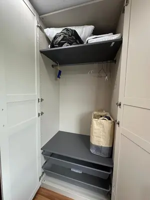 a walk in closet with white cabinets and black shelves at Cozy Room - On Nut - Wi-Fi, Gym, Pool in Bangkok