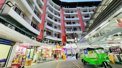 a green golf cart parked in a building at Bangkok-Pratunam Hotel in Bangkok
