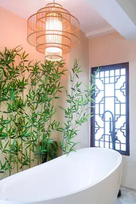 a bathroom with a bath tub and plants at Chinatown No9 Boutique Hotel in Bangkok