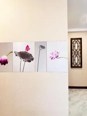 a wall with pictures of flowers on it at Chinatown No9 Boutique Hotel in Bangkok
