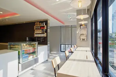 a dining room with a long table and chairs at Easy Planet Bangkok Surawong in Bangkok