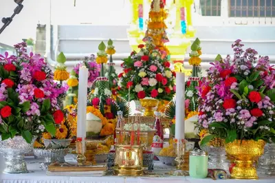 a table filled with flowers in vases and candles at B32 Apartment in Bangna