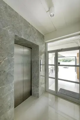 a walk in shower in a room with a glass door at B32 Apartment in Bangna