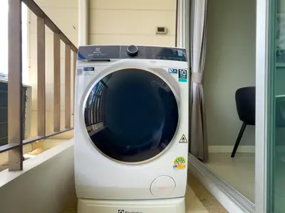 a washing machine is sitting in a room at Near BTS l Fully Furnished l Pool and Gym in Bangkok