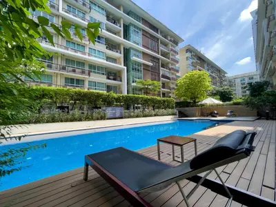 a swimming pool with a bench next to a building at Near BTS l Fully Furnished l Pool and Gym in Bangkok