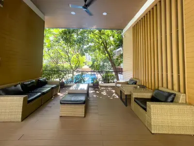 a patio with couches and tables in a building at Near BTS l Fully Furnished l Pool and Gym in Bangkok