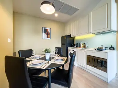 a kitchen with a table and chairs in a kitchen at Near BTS l Large 50 sqm l Luxury facilities l Rooftop Pool in Bangkok