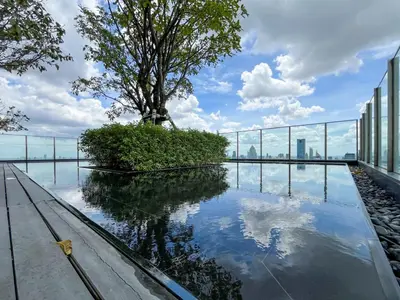a reflecting pool on the roof of a building with a tree at Near BTS l Large 50 sqm l Luxury facilities l Rooftop Pool in Bangkok