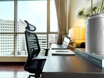 a desk with a laptop computer sitting on top of it at 300m BTS l Large 110 sqm l Pool and Sauna in Bangkok
