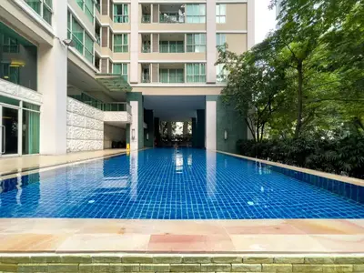 an empty swimming pool in front of a building at 300m BTS l Large 110 sqm l Pool and Sauna in Bangkok