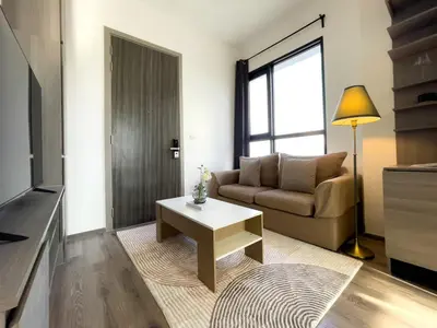 a living room with a couch and a coffee table at Near BTS l Central Sukhumvit l Pool and Sauna in Bangkok