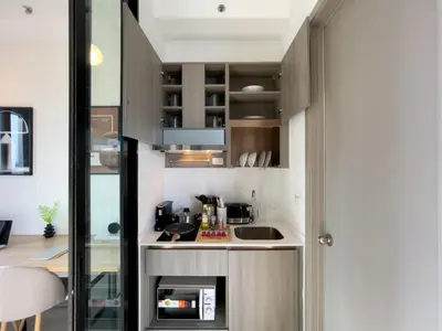 a small kitchen with a sink and a counter at Near BTS l Central Sukhumvit l Pool and Sauna in Bangkok