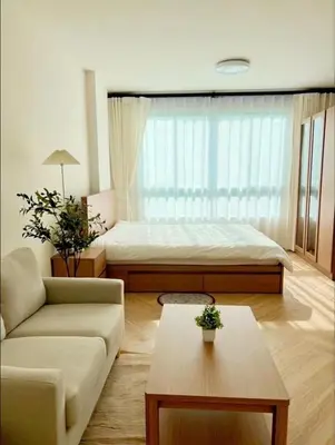 a living room with a bed and a couch at Minimal Condo At Ramkhamhaeng 64 in Sathani Ban Hua Mak