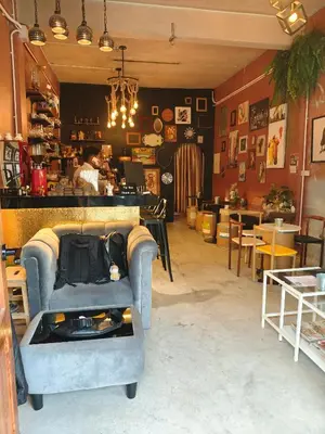 a living room with a blue couch and a table at Bangkhunnon Station Hostel in Sathani Thon Buri