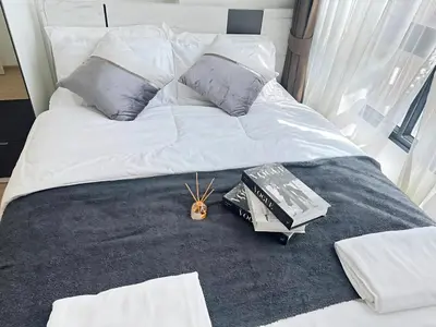 a bed with some books and books on it at Cozy&Bright apartment -Onnut BTS in Bangkok