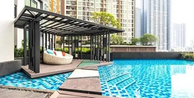 a swimming pool with a pergola next to a building at Cozy&Bright apartment -Onnut BTS in Bangkok
