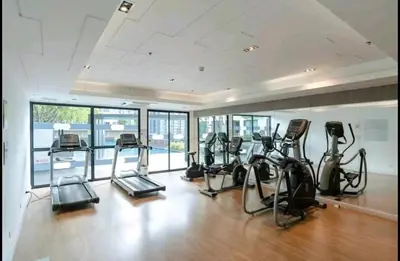 a gym with several treadmills and elliptical machines at Cozy&Bright apartment -Onnut BTS in Bangkok