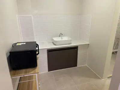 a small bathroom with a sink and a tv at Siam Place - In the Heart of Bangkok in Bangkok