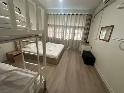 a dorm room with two bunk beds and a window at Siam Place - In the Heart of Bangkok in Bangkok
