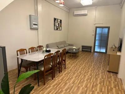 a living room with a table and chairs and a couch at Siam Place - In the Heart of Bangkok in Bangkok