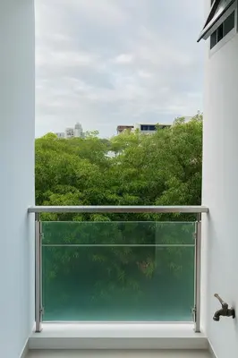 a window in a room with a view of trees at City View Condo 5 mins to MRT Sutthisarn in Bangkok
