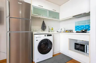 a kitchen with a washer and dryer in it at Warm&Cozy Stay near BTS Thonglor in Bangkok