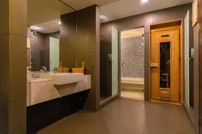 a bathroom with a white sink and a shower at Warm&Cozy Stay near BTS Thonglor in Bangkok