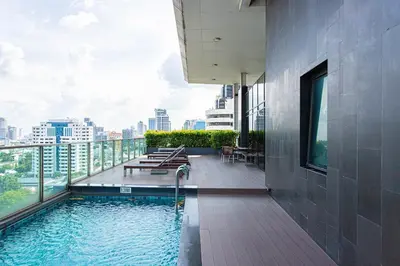 a swimming pool on the roof of a building at Warm&Cozy Stay near BTS Thonglor in Bangkok