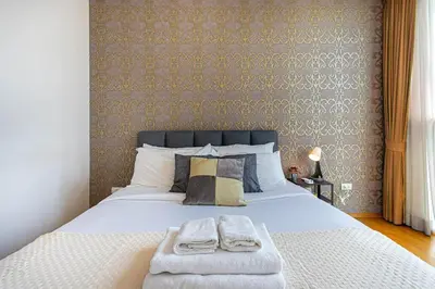 a bedroom with a bed with two towels on it at Warm&Cozy Stay near BTS Thonglor in Bangkok