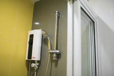 a shower with a soap dispenser in a bathroom at SU 22 in Bangkok