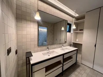 a bathroom with a sink and a mirror at Tree Villa Bangkok in Bangkok