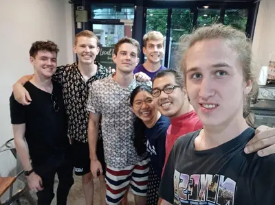 a group of young men posing for a picture at LCT Hostel Bangkok in Bangkok