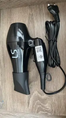a hair dryer sitting on top of a wooden floor at Thonglor Next to BTS Condominium in Bangkok