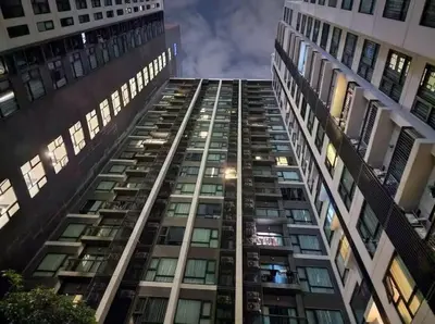 a tall building with many windows at night at Thonglor Next to BTS Condominium in Bangkok