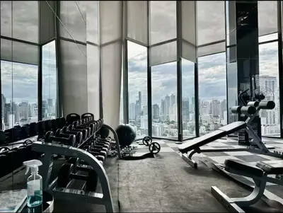 a gym with a view of a city at Thonglor Next to BTS Condominium in Bangkok