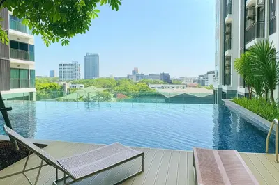 a swimming pool in the middle of a building at Thonglor Next to BTS Modern Condo - Fitness gym with full view in Bangkok