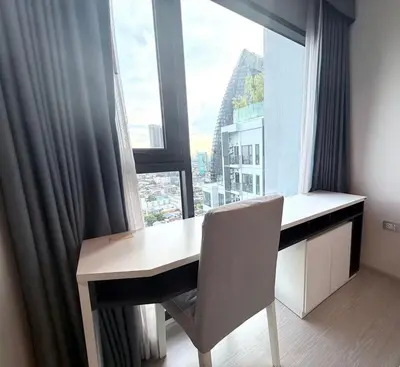 a desk with a chair in front of a large window at Thonglor Next to BTS Modern Condo - Fitness gym with full view in Bangkok