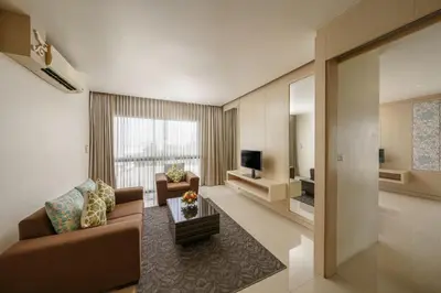 a living room with a couch and a television at Aspira Petchkasem in Ban Khlong Om Noi