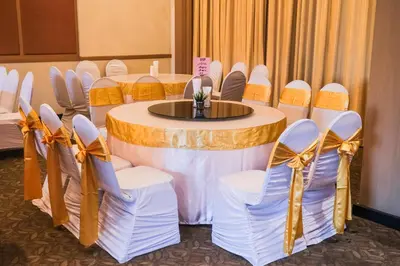 a round table with chairs and a table with bows at Aspira Petchkasem in Ban Khlong Om Noi