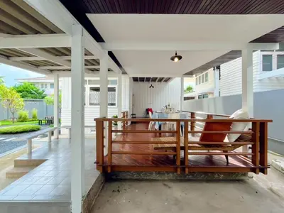 an open porch with a wooden bench on a patio at Rare Find 80 yrs Heritage Peaceful House in BKK in Bangkok Yai