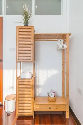 a wooden bunk bed with a plant on top at Minimal House Maximum Happiness in Thung Maha Mek