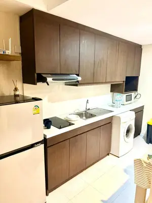a kitchen with a white refrigerator and a dishwasher at Noble Remix Thonglor - Direct BTS Access - Super Fast Wi-Fi in Bangkok