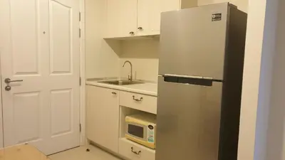 a stainless steel refrigerator in a kitchen with a microwave at Manor Riverfront Stay, Chaophraya View Condo, Nonthaburi in Ban Tha It (1)