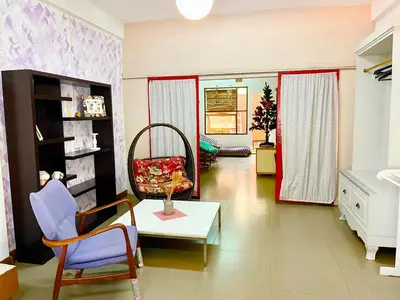 a living room with a chair and a table at Anne & Tan Stylist Homestay in Bangkok