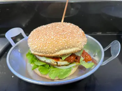 a sandwich on a plate on a table at Anne & Tan Stylist Homestay in Bangkok