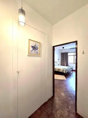 a hallway with a room with a bed and a mirror at Anne & Tan Stylist Homestay in Bangkok