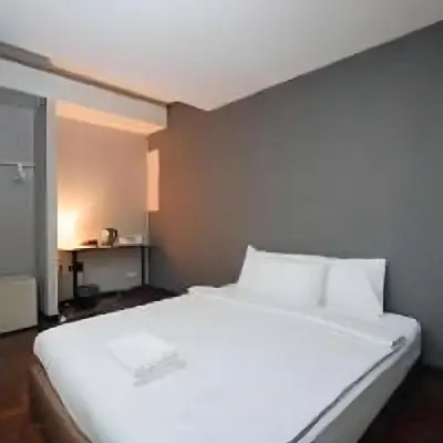 a large white bed in a small room at XX GO INN Silom BTS Saint Loius - เซนหลุย in Yan Nawa