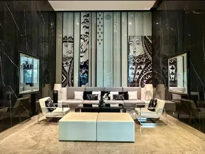 a living room with a couch and a table and chairs at Peaceful Stylish and cozy condo in Khlong Toei