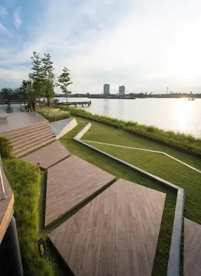 a walkway next to a body of water at The Politan Aqua, River Front in Ban Sai Ma